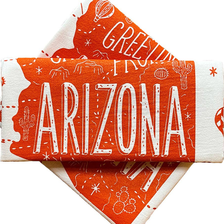 Stack of red and white Arizona-themed towels on a white background