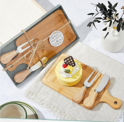 Wooden cutting board set with cake and decorative items on a table