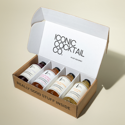 Box of cocktail ingredients from Iconic Cocktail Co. on a beige background
