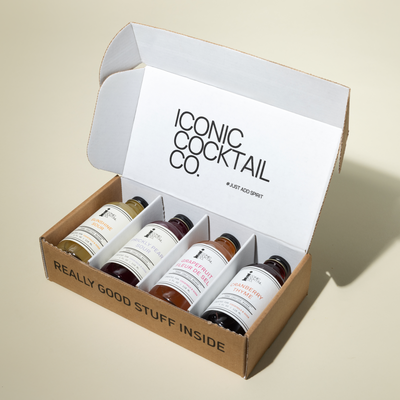 Box of cocktail ingredients from Iconic Cocktail Co. on a beige background